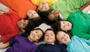 Kids sitting in a circle wearing colourful t-shirts